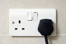Plug in an electric wall socket.